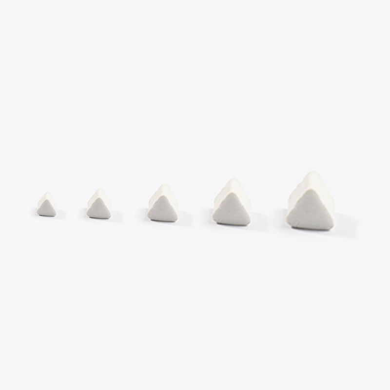White ceramic finishing media in five sizes.
