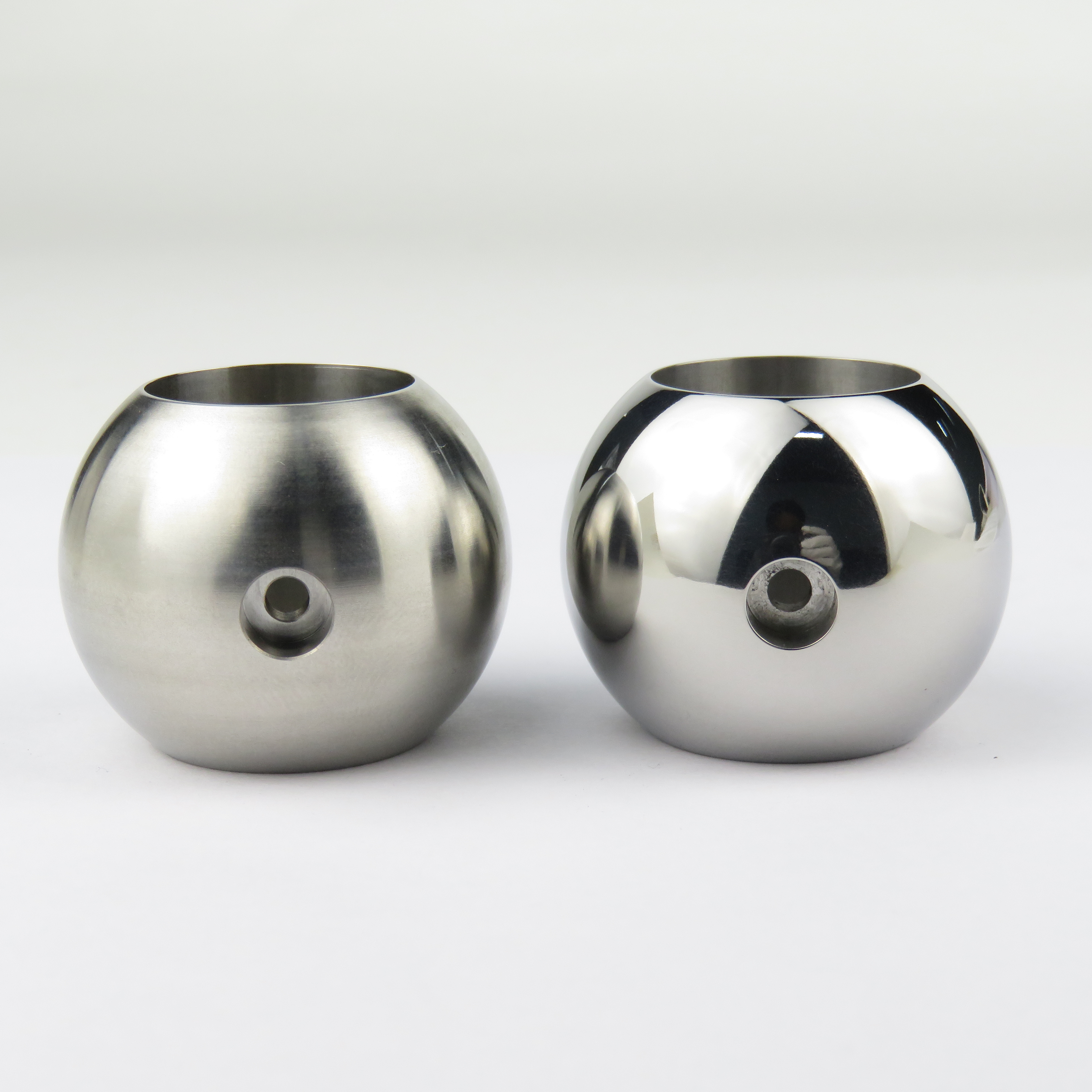 Archive photograph of metal robot-joint components before and after finishing.