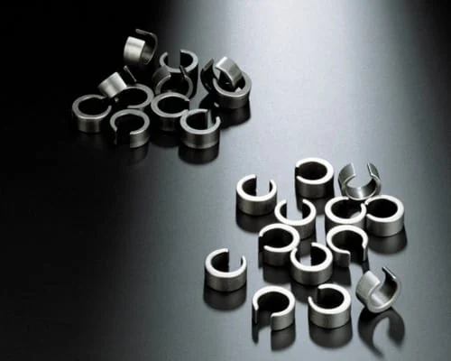 Stamped spring clips used to compare surface condition during a mass finishing trial