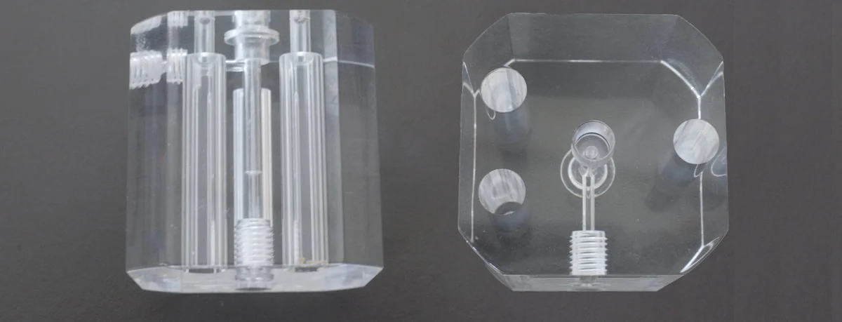 Machined acrylic parts showing cloudy surface and visible machining marks before polishing