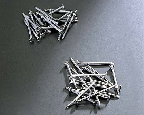 Small metal nails in separate batches for surface finishing evaluation