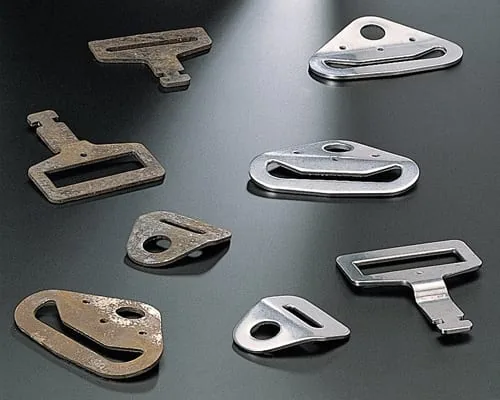 Stamped metal buckle components used for a deburring and surface finishing evaluation