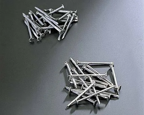 Small metal nails in separate batches for surface finishing evaluation