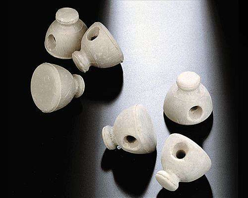Small cap-shaped parts with an internal bore, the feature class that decides reach