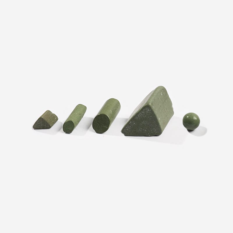 Ceramic vibratory tumbling media in the four standard cutting shapes: triangle, angle-cut triangle, cylinder and ball