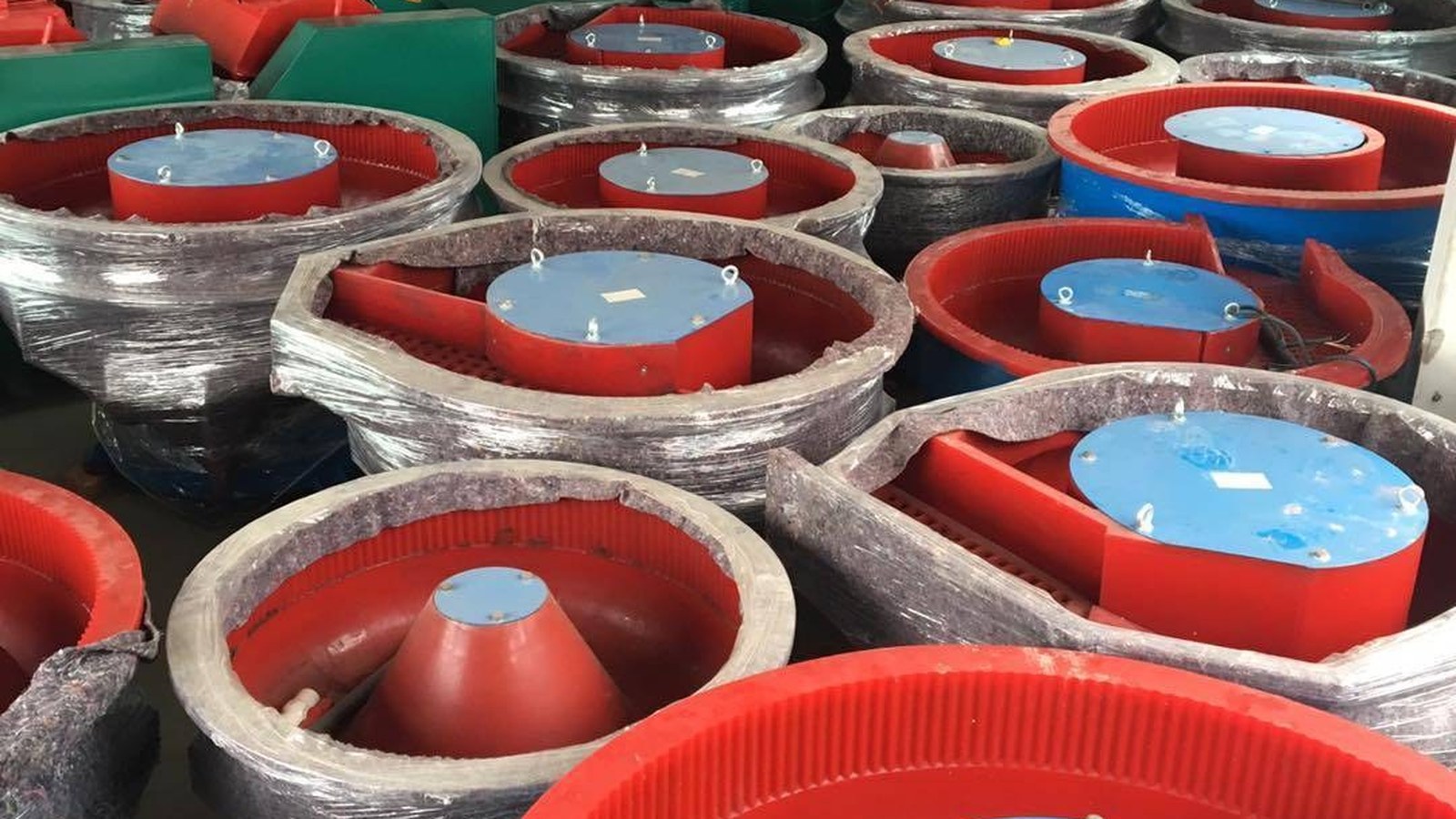 Finished vibratory bowls stacked in rows, ready to be checked and packed