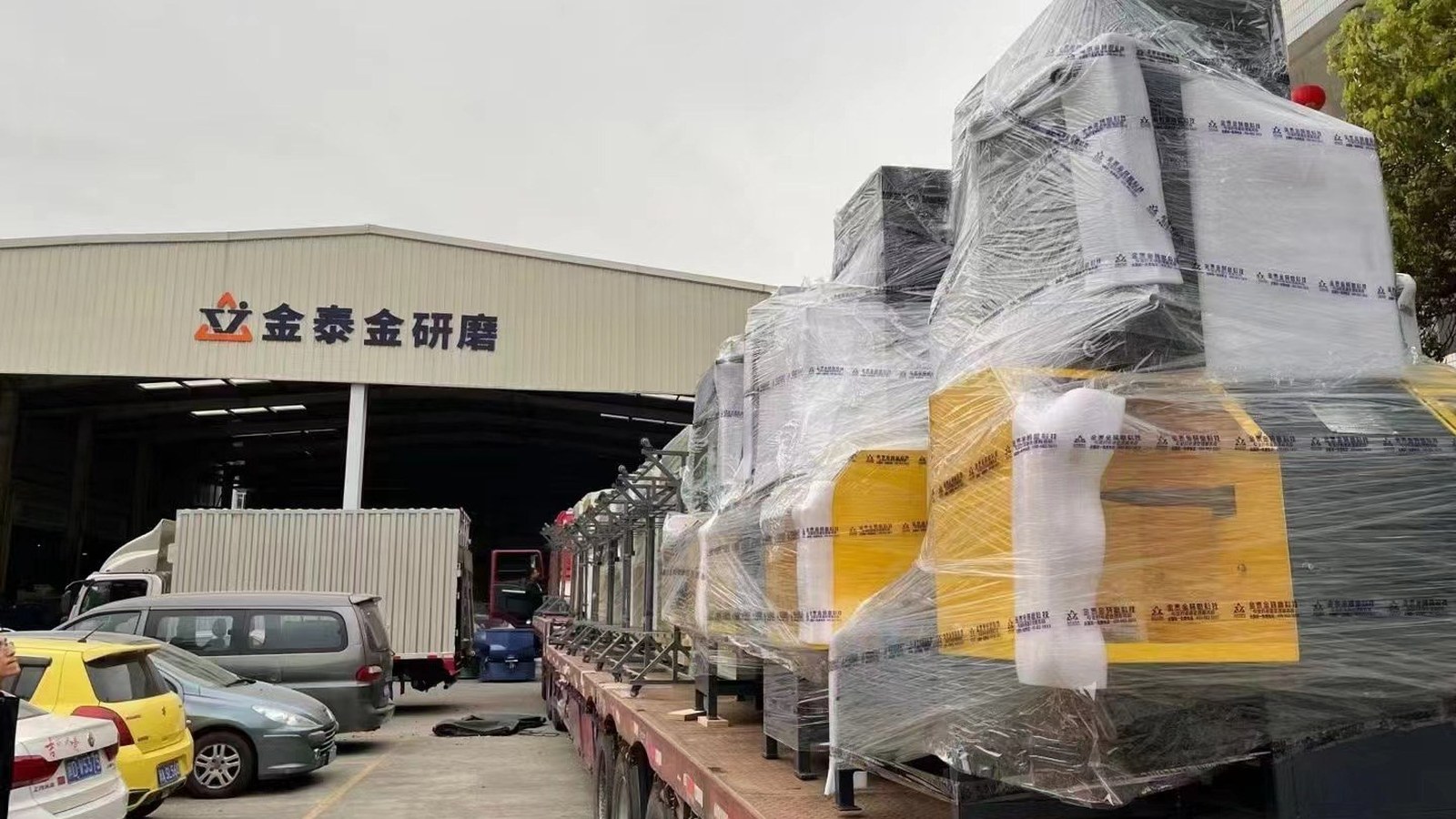 Machines crated and wrapped on a flatbed truck, loaded for export