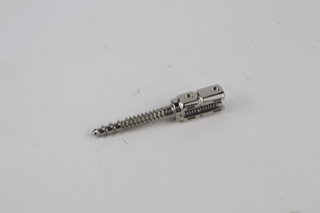 A small threaded implant screw: the scale and the feature that make jewellery work a fixture-and-batch problem