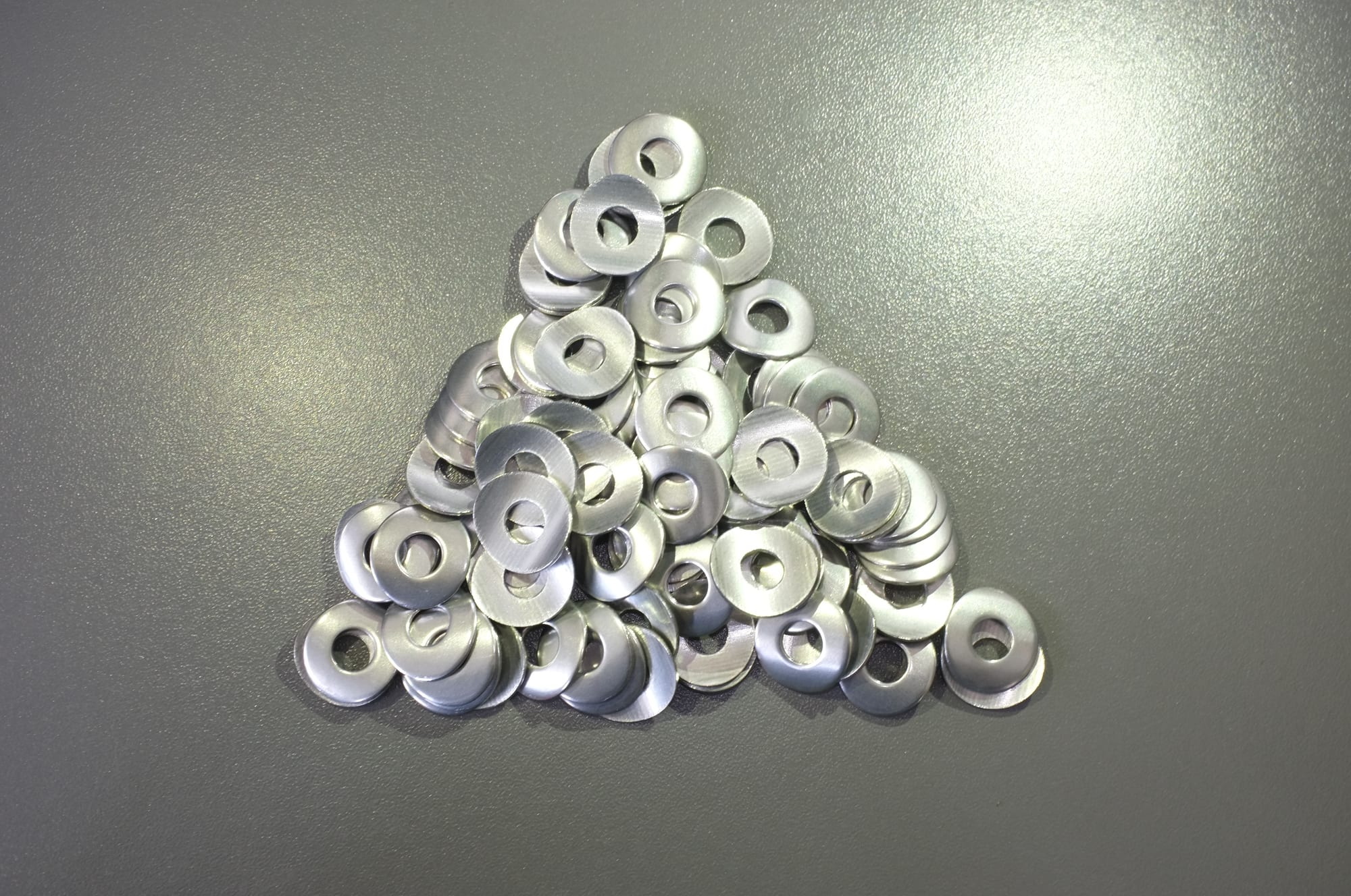 The same washers after finishing, with rounded edges and an even bright surface